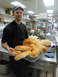 Matt Weafer, chef at Niko's baker, holds a tray of gourmet breads.